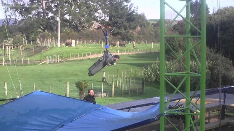 The free fall with patrons strapped in the swoop swing