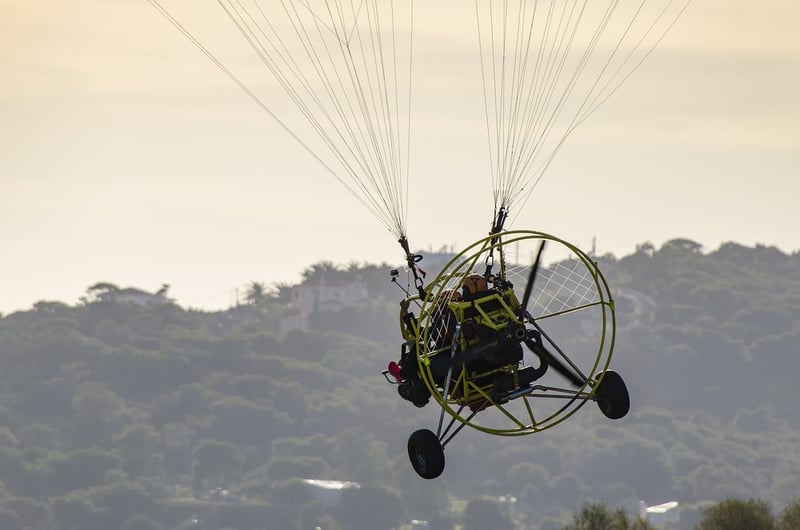 A patron flying a paramotor