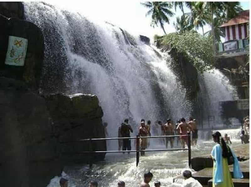Enjoying a Dip at the Thiruparappu Falls