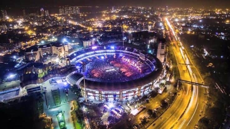 Aerial view of the stadium hosting a concert at night 