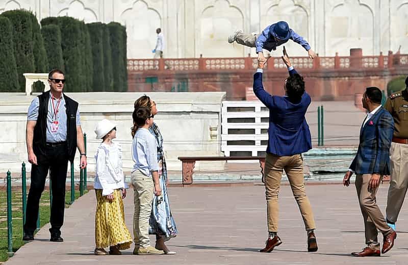 Justin Trudeau playing with his son at the Taj Mahal
