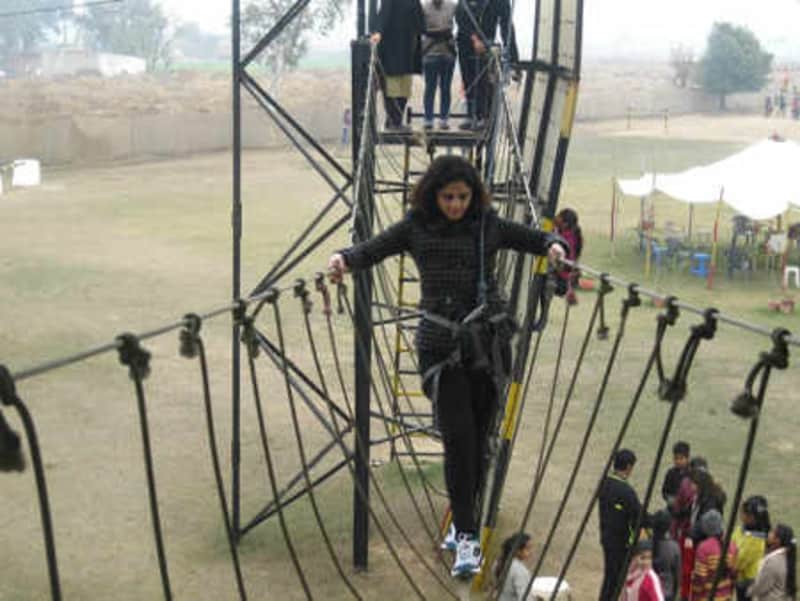 A visitor tries one of the obstacle courses at the park