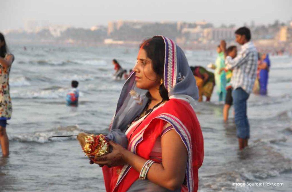 Devotees perform special Chhath Puja rituals at Juhu Beach, Mumbai.